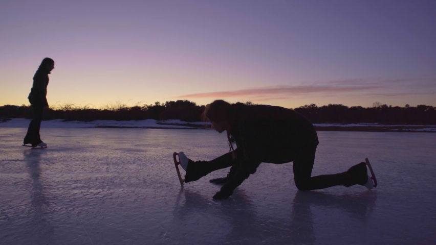 Group of figure skaters warming up, doing splits on frozen lake