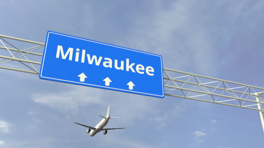 Milwaukee city road sign below flying airplane Royalty-Free Stock Footage #1068668978