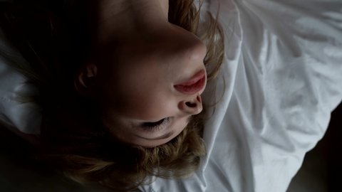 excited woman is feeling extasy in bedroom, orgasm and pleasure, sex and self-satisfaction, closeup of female face in bed