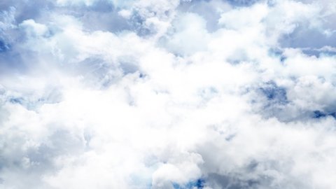 Flying through clouds. White clouds moving on camera on blue sky