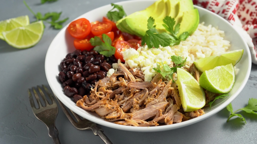 Pork carnitas bowl or burrito bowl with rice, tomatoes and avocado
