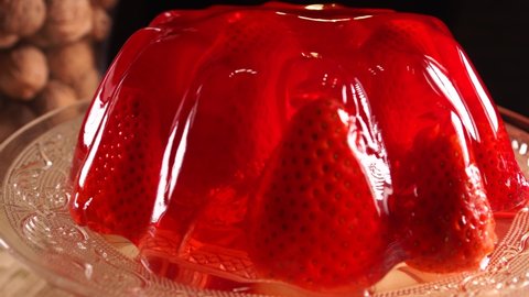 Jelly with whole strawberries close up view