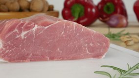 Cut a slice of raw red meat and take it. Slice the pork loin. Preparing food. Raw ingredients. Close up, 4k video.