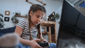 little girl playing video game on gamepad. kid dream stay home computer addiction. girl playing tablet online fun games. addiction to online games addict kid. child play video game dream