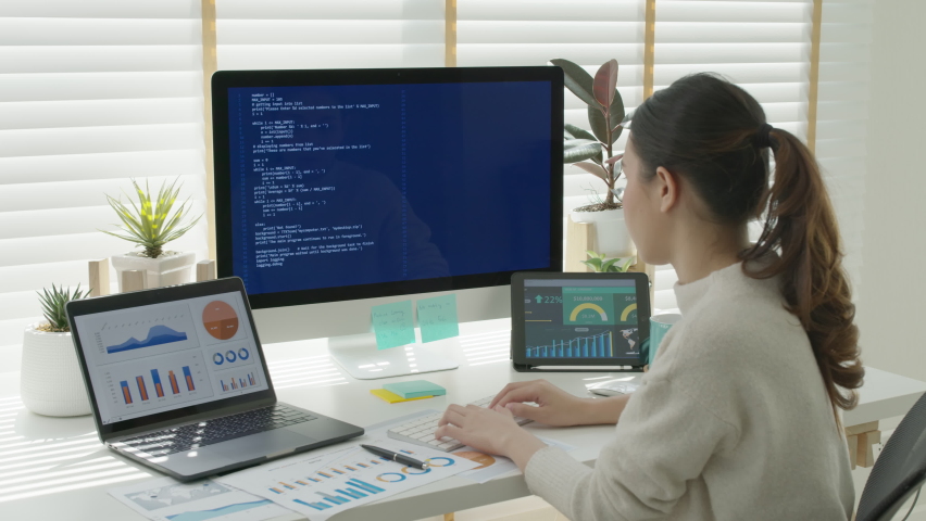 Back rear view of young asian woman, freelance data scientist work remotely at home coding programmer on Big data mining, AI data engineering, IT Technician Works on Artificial Intelligence Project. Royalty-Free Stock Footage #1068687542