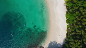 4K. 59.94FPS. Aerial view shot. Drone camera over beach. Nature video view of beautiful tropical beach and sea in sunny day. Palm tree at beach. At Phuket, Thailand.