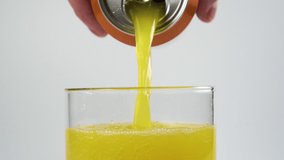 Citrus carbonated drink with bubbles is poured into a glass from an aluminum can in a hand on a white background close-up. Slow motion - Powered by Shutterstock - Get 15% off with code: PIKWIZARD15