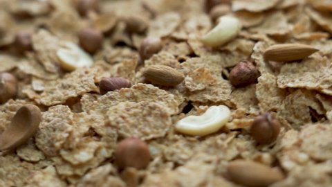 Close-up of Healthy Flakes with Nuts, Almonds, Cashews and Hazelnuts, Rotation. Natural and Healthy Vegan Food with Vitamins. The Concept Of A Proper Vegetarian Diet.
