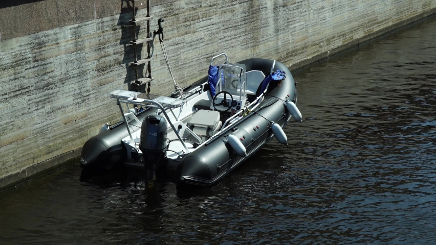 Motor boat, a boat at the granite embankment. Fontanka River in St. Petersburg.