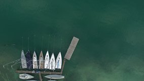 A nice drone shot of many small sail boats on anchorage in the lake