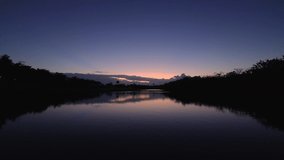 Sunset over lake in a golf course field. Tropical nature, 4k video