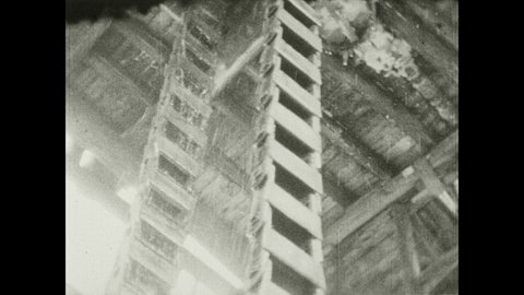 1930s: Automated bucket system draws brine up into salt factory tower. Bamboo pipes run both up and down from brine tower in salt factory.