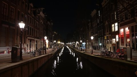 AMSTERDAM, NETHERLANDS – 5 MARCH 2021: Empty Red Light nightlife and adult entertainment district in central Amsterdam. Coronavirus Covid-19 night-time curfew and lockdown measures in the Netherlands.
