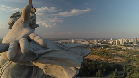 Volgograd, Russia - 11 june 2020 year: Epic monument homeland symbol hand close. Memorial on mound. Majestic cityscape, center downtown. Sunset, clouds. Hero city soviet union Stalin War. Summer