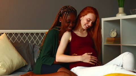 mixed race couple awaiting a baby in room