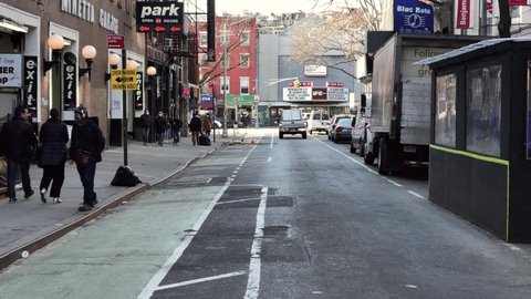 NYC, USA - MARCH 4, 2021: skateboarder skateboarding down West 3rd Street IFC movie theater Greenwich Village New York City.