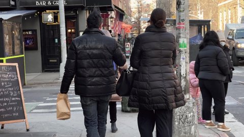 NYC, USA - MARCH 4, 2021: couple walking on MacDougal Street Greenwich Village New York City.