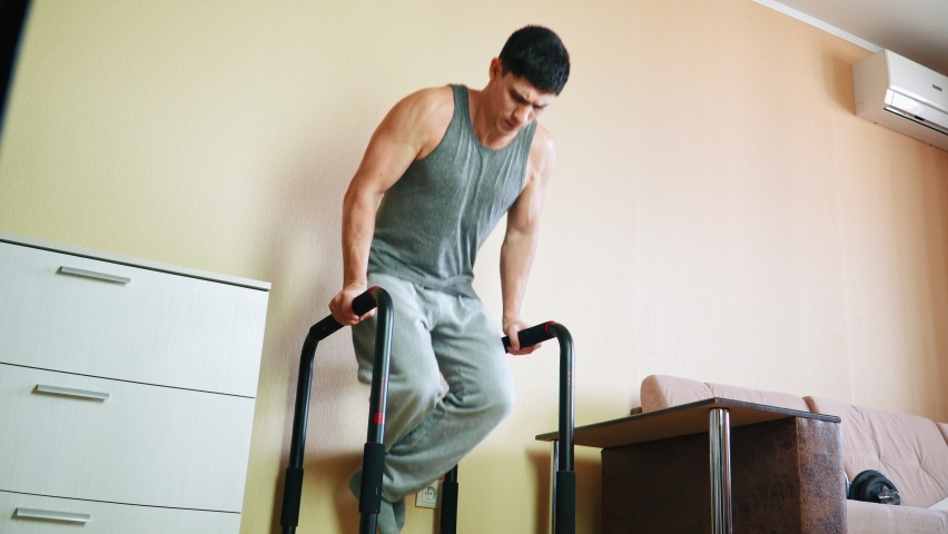 Muscular Athletic Man Doing Dips Exercise at Home. Fitness Classes Without Leaving Home. Mindful Living, New Beginning, Self-improvement, Personal Growth Workout.