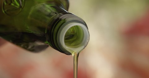 Bottle Neck of Olive Oil Pouring Down a Macro Shot in Slow Motion