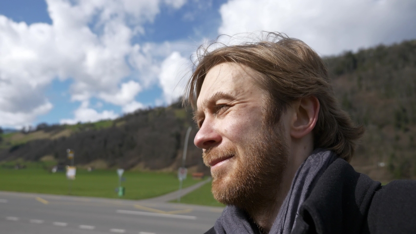 Close-up Portrait Tired Tourist Male Face. Serious Confident Man with Beard Traveling Along Country Road. Traveler Wanderer on Rural Scene in Mountain Region | Shutterstock HD Video #1068742943