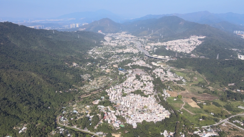 Villages with road traffic in the rural suburbs of Pat Heung, Shek Kong, and Kam Sheung Road Station, Hong Kong Aerial Top View Close up Shot