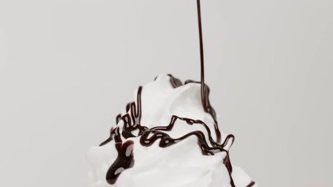 Pour chocolate sauce on top ice cream chocolate whipped cream on white background, Food concept Front view.