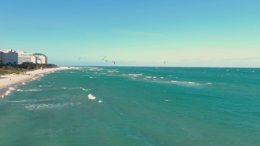 Tourists Parasailing On The Midbeach Section Of Miami Beach, Florida, United States. aerial, left slider