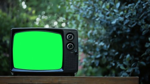 Vintage TV Set with Green Screen Outdoors. Zoom In. You can replace green screen with the footage or picture you want. You can do it with “Keying” effect in After Effects. 4K Resolution. 