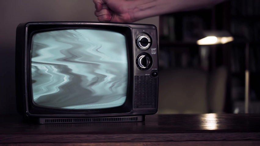 Male Hand Hitting an Old TV Set until Green Screen Appears. You can replace green screen with the footage or picture you want. You can do it with “Keying” effect in After Effects. 4K Resolution. | Shutterstock HD Video #1068752126