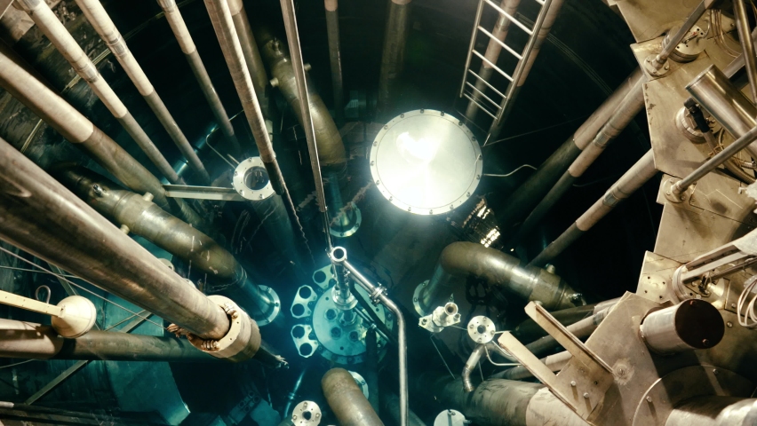 A fuel rod being inserted in a reactor vessel at the nuclear power plant. Royalty-Free Stock Footage #1068758084