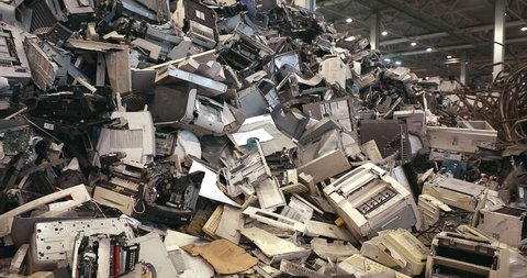 A mountain of old office electronic and household appliances at a recycling and recycling plant