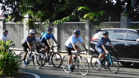 Pulo Mas Jakarta, Indonesia - February 21 2021: A group of people pumping adrenaline by racing bicycles on the highway.