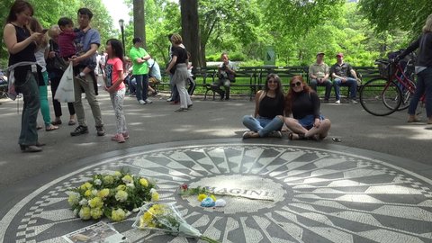 NYC, NEW YORK, USA - MAY 25, 2017:
People at the Strawberry Fields (John Lennon memorial) in NYC Central Park.