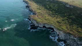 Panoramic video of picturesque rocky coastline with green fields and trees. Spring time at the Black sea coast, Yailata - national archeological and nature reserve, Bulgaria