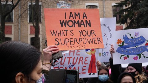 Kharkiv, Ukraine - March, 08, 2021: Women's Solidarity March. Many people are standing in the square with placards in their hands. Pride, the fight for gender equality