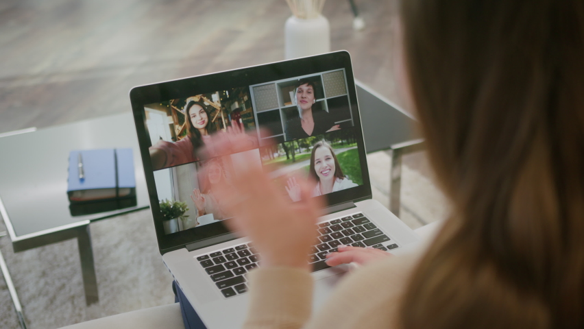 Online group video call conference of friends from home. Woman talks with friends at video chat using laptop. Self-isolation at COVID-19 Pandemic. Royalty-Free Stock Footage #1068778124