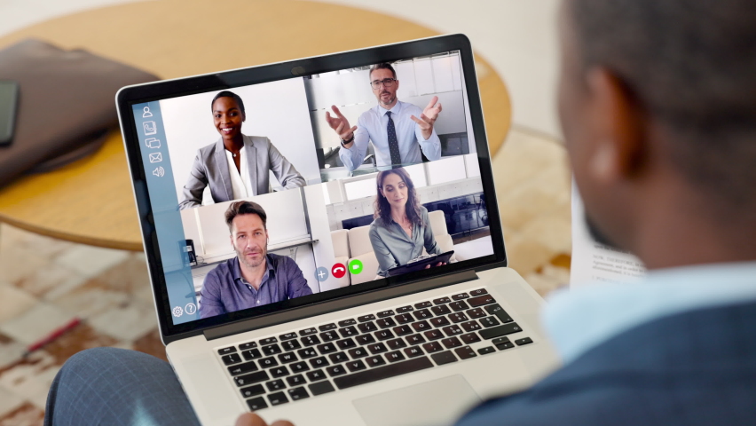Businessman talking to his colleagues about plan in video conference. Multiethnic business team using laptop for online meeting in video call. Group of people in smart working from home during covid19 Royalty-Free Stock Footage #1068792209