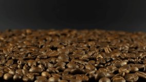 Rotation close-up of coffee beans 360. Golden selected aromatic beans rotate is used to prepare a coffee drink. 4k video food and drinks.