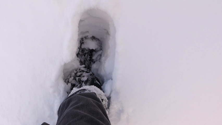 Slow motion. man walking in a deep snow to the knee in Cold weather.
-50 °C. adventure in Erzurum, Turkey. Human footprints. Track, Tracks. Snowfall in the winter. Footprint. foot prints, feet print