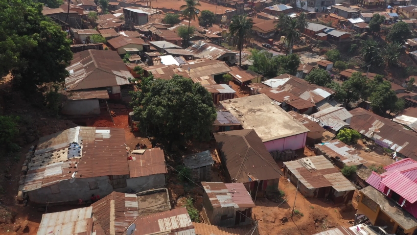 Aerial Freetown Sierra Leone homes mountain village poverty. Sierra Leone on the coast of west Africa is a nation that suffers with extreme poverty and hunger. Tropical climate environment. Royalty-Free Stock Footage #1068802991