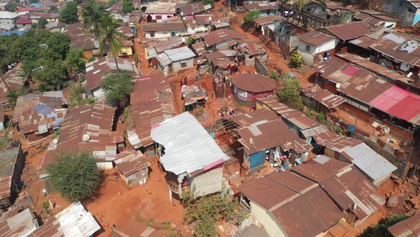 Aerial Freetown Sierra Leone poor homes mountain village. Sierra Leone on the coast of west Africa is a nation that suffers with extreme poverty and hunger. Tropical climate environment. Royalty-Free Stock Footage #1068802994