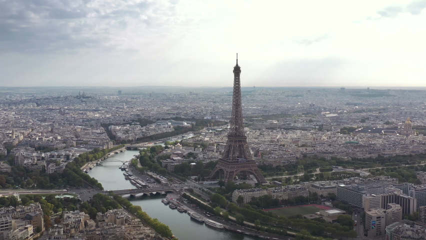 Cloudy day flight over paris city center famous tower riverside aerial panorama 4k france