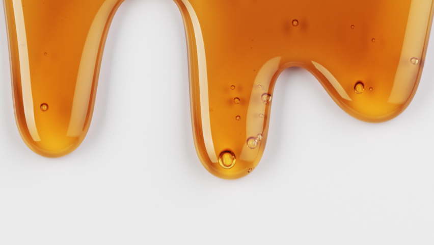 Close up of flowing melted caramel sauce macro on white background | Shutterstock HD Video #1068809846