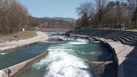 TACEN, SLOVENIA. 2.3.2020. Professional athletes training canoe slalom on white water rapids. Canoe slalom competition course on fast flowing river