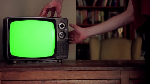Man hitting an Old TV with Green Screen. Close-Up. You can replace green screen with the footage or picture you want. You can do it with “Keying” effect in After Effects. 4K Resolution. 