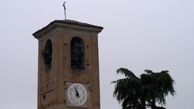 Ancient bell tower rings the bells on Sunday after mass. Video with audio 4K