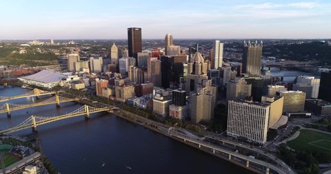PITTSBURGH, PENNSYLVANIA - SEPTEMBER 29, 2019: Pittsburgh Cityscape, Pennsylvania. City is Famous because of the bridges. Sunset Light. Business Skyscrapers and Three Bridges in Background