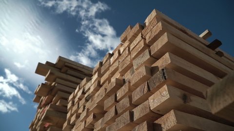 Wooden bars. Rafters for building a house. Packs of lumber at the Sawmill. Big framework. Natural materials from wood. Time lapse. Pine Boards in large packages. Manufacture of wooden products
