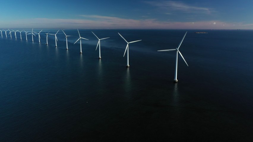 Oceanic wind turbines at the coastal windmill farm, Middelgrunden, just outside Copenhagen, Denmark. 