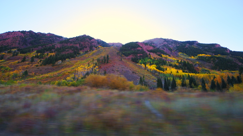 Maroon Bells car point of view side panning by open view and orange fall trees in Colorado in rocky mountains and autumn yellow foliage and blue sky | Shutterstock HD Video #1068846887